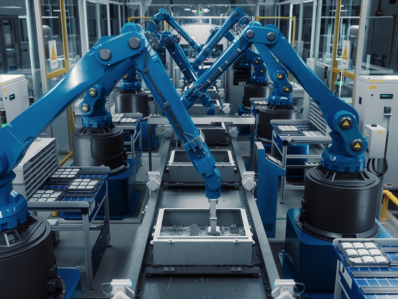 Robotic arms in a factory setting performing tasks.